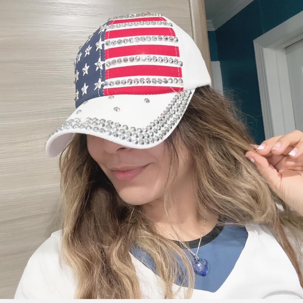 Adjustable white cap with U.S. flag design.